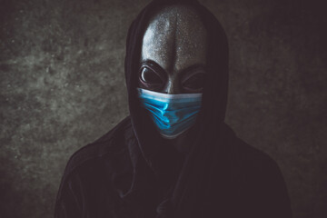 Alien creature with medical mask. Alternative concept about coronavirus