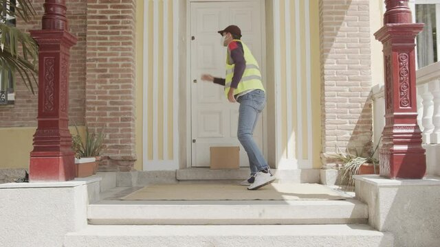 The courier delivers parcel at home. Delivery in quarantine. Safe delivery without contact