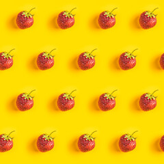 Strawberry seamless pattern, strawberries on yellow colored background, top view, creative minimalist flat lay, summer pattern