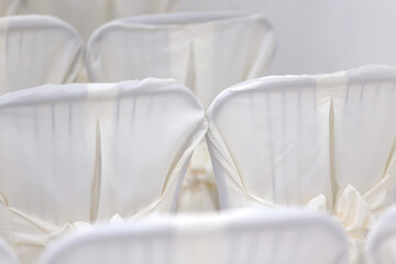 Luxurious texture of white chairs with a bow