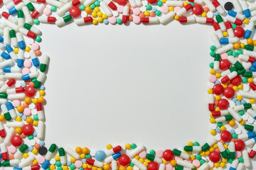 Different pills, capsules scattered in the shape of rectangle over white background. Health care, vitamins and treatment concept