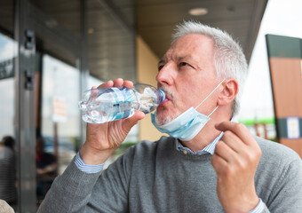 Man drinking a bottle of water