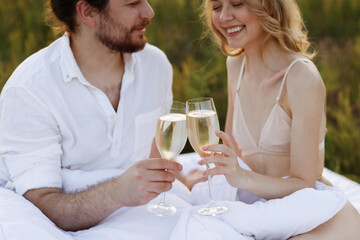Couple holding glasses of champagne and smiling