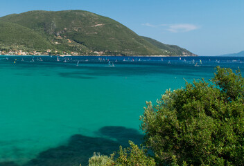 People enjoying windsurf on turquoise sea during summer in Lefkada island, Greece