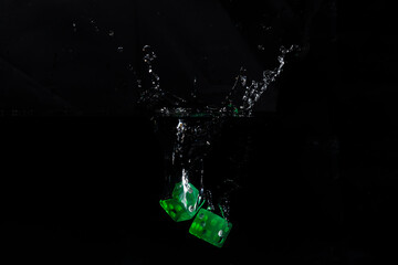 Pair of green dice dropped into water