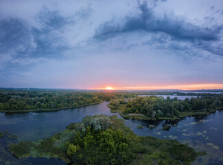 Fototapeta na wymiar amazing landscape at sunset. aerial view of river and blue cloudy sky. natural background. drone shot