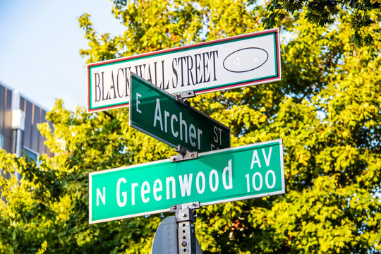 Black Wall Street and N Greenwood Avenue  and Archer street signs - closeup - in Tulsa Oklahoma with bokeh background