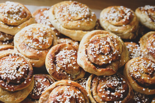 Batch of freshly baked homemade Swedish style cinnamon rolls / buns with pearl sugar -Image