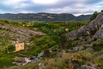 old abandoned stone house in a valley by the river