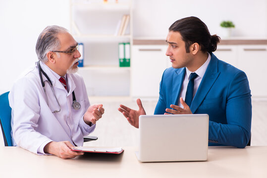 Young businessman meeting with old doctor
