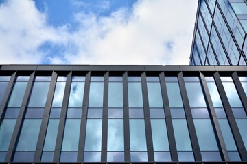 Facade texture of a glass mirrored office building. Fragment of the facade. Modern architecture of the office building.