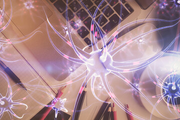 Neuron hologram drawings over computer on the desktop background. Top view. Multi exposure. Concept...