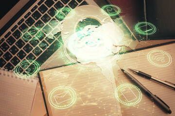 Social network hologram drawings over computer on the desktop background. Top view. Double exposure.