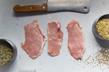 
Thin slices of marinated pork on quartz counter