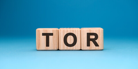 TOR word cube on a blue background. Business concept.