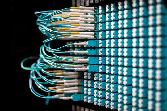 Fiber optic cables and connectors in a data center network patch panel