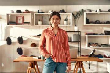 Ready for creativity. Portrait of young smiling female worker looking at camera while standing in...