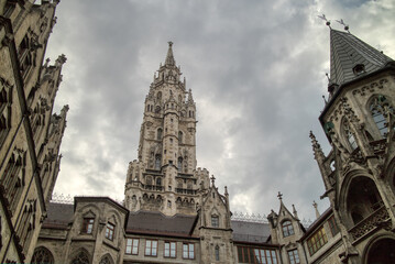 Fototapeta na wymiar Old-fashioned architectural buildings against grey cloudy sky in Munich, Germany.