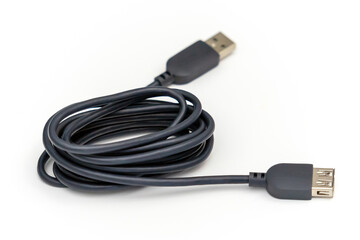 Gray USB extension cable set on a white table.