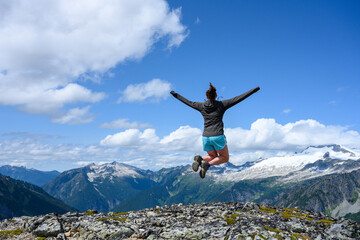 Woman Stretches out Arms in Jump