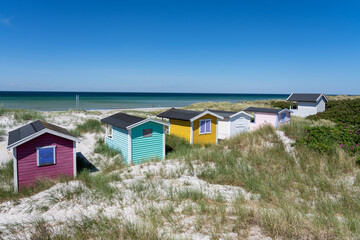 Colorful beach huts on beautiful white sand beach in Falsterbo, Sweden.
