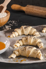 Producing classic small croissants at home or cafe. French pastry goods. Family cooking concept. Prepare croissant for bake