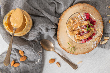 Breakfast oatmeal porridge with raspberries, almond, cinnamon, almond butter and coconut. Healthy breakfast delicious homemade english breakfast concept