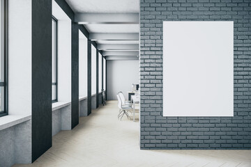 Coworking loft interior with blank banner on brick wall.