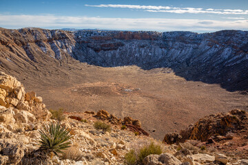 A Winter view of the Barringer Meteor Crater with snow in the shadows. Along Interstate 40 near...