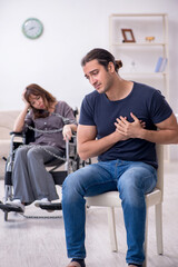 Fototapeta premium Disabled wife and young husband at home