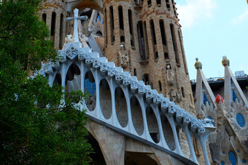 Obraz premium The Façade of Passion of Sagrada Familia has an almost skeletal feel, with pillars resembling bones & expressive sculptures of Biblical figures. The temple is located in Barcelona, Spain.