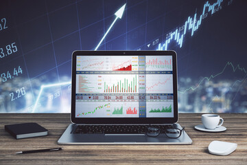 Close up of laptop with forex chart on desktop