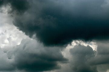 Naklejka na ściany i meble Dramatic sky with sun and dark clouds