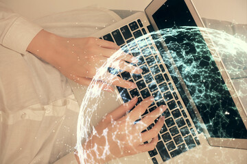 Double exposure of woman hands working on computer and social network theme hologram drawing. Top View. People connection concept.
