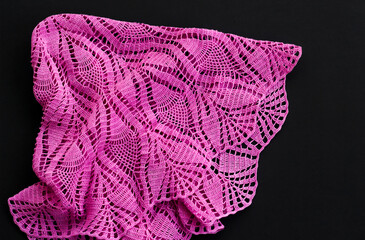 Close-up taken of handmade lace tablecloth on black background with copy space.