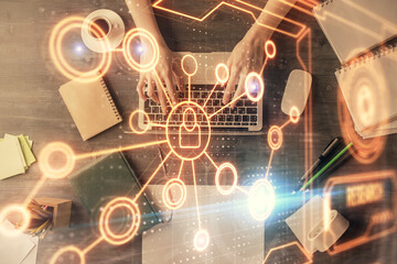Double exposure of woman hands working on computer and social network theme hologram drawing. Top View. People connection concept.