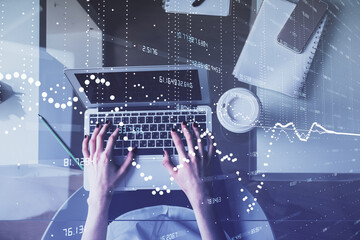 Double exposure of woman hands working on computer and data theme hologram drawing. Top View. Technology concept.