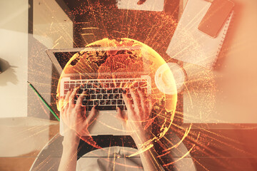 Double exposure of woman hands working on computer and social network theme hologram drawing. Top View. People connection concept.