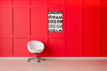 Armchair near color wall in room