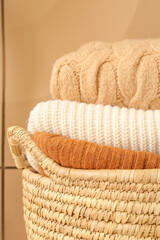 Basket with clothes on color background, closeup