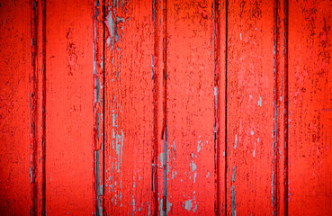 Cracked and peeling red oxidized paint on wood with texture and grunge finish
