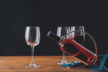Naklejka na ściany i meble Holder with bottle of wine and glasses on table