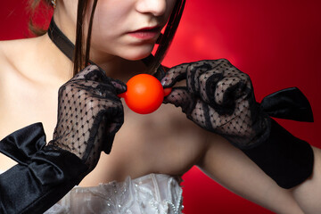 Gag the ball in your mouth around the neck. Leather ball for sex games. Girl puts on a red gag....