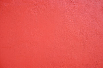 Living coral painted wall, visible marks of toolwork and brush strokes.