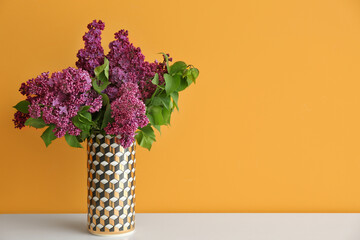 Vase with beautiful flowers on table near color wall