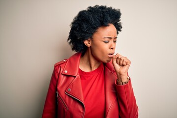 Young beautiful African American afro woman with curly hair wearing casual red jacket feeling unwell and coughing as symptom for cold or bronchitis. Health care concept.