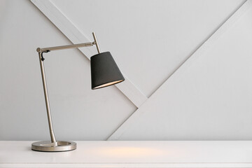 Modern lamp on table in room