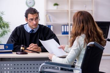 Injured woman and male judge in the courtroom
