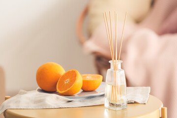 Citrus reed diffuser on table in room