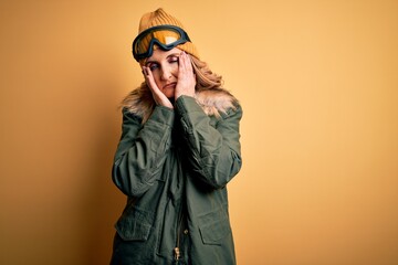 Middle age beautiful blonde skier woman wearing snow sportwear and ski goggles Tired hands covering face, depression and sadness, upset and irritated for problem